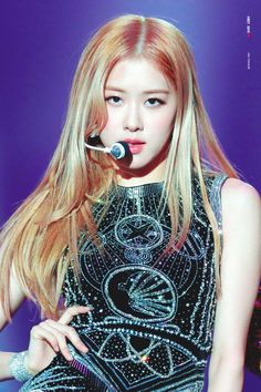 This contains an image of BLACKPINK's Rosé on stage