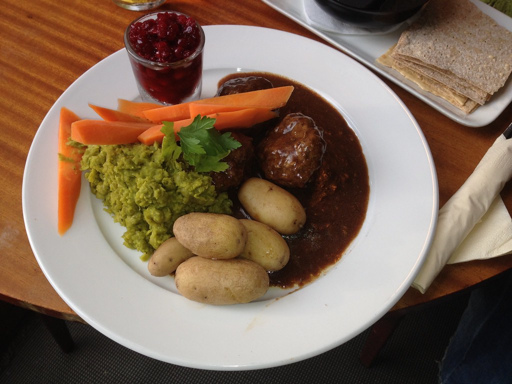 A Norway food in white plate in which potato, carrot, coriander and some other food is kept 