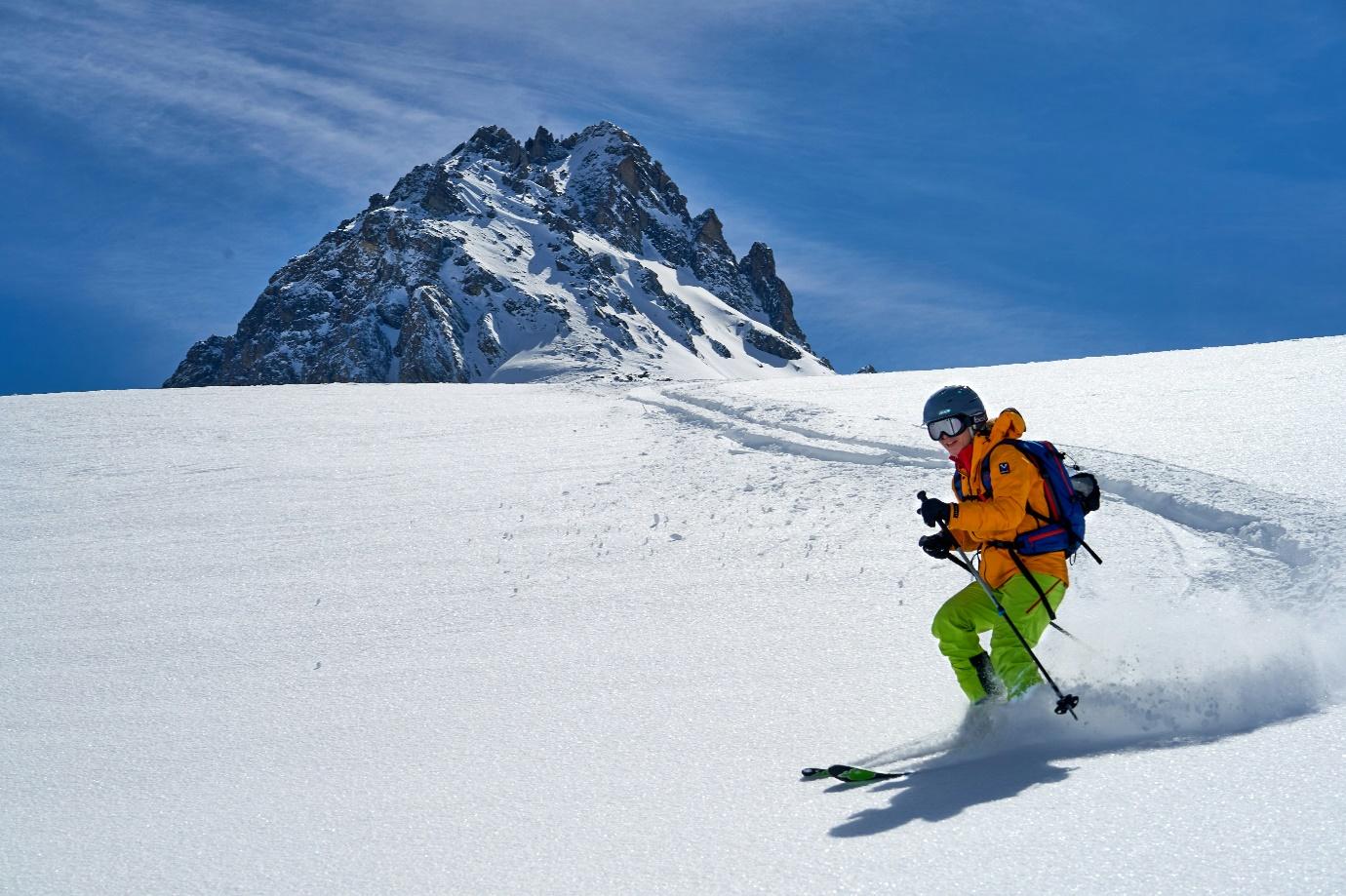 A person skiing down a snowy mountain  AI-generated content may be incorrect.