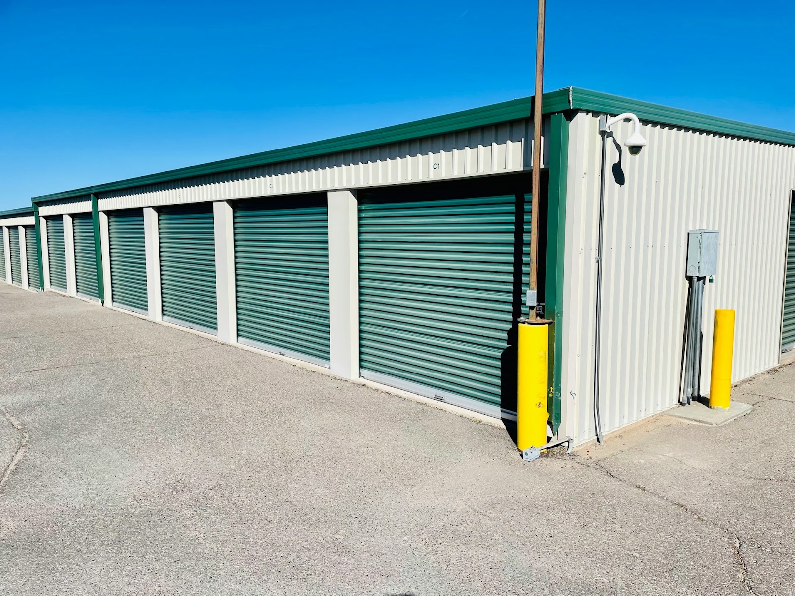 A row of simple self-storage units on a sunny day