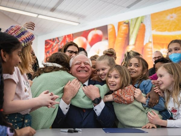 An impossibly cute picture of school-children embracing Gov. Walz, and him hugging them right back