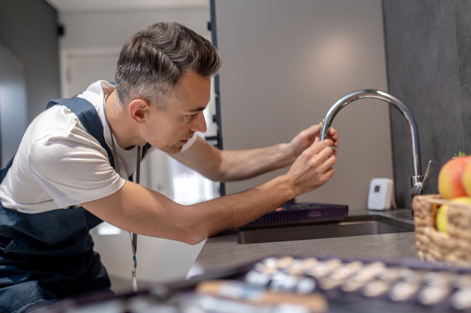 Technician working on a sink repair. 