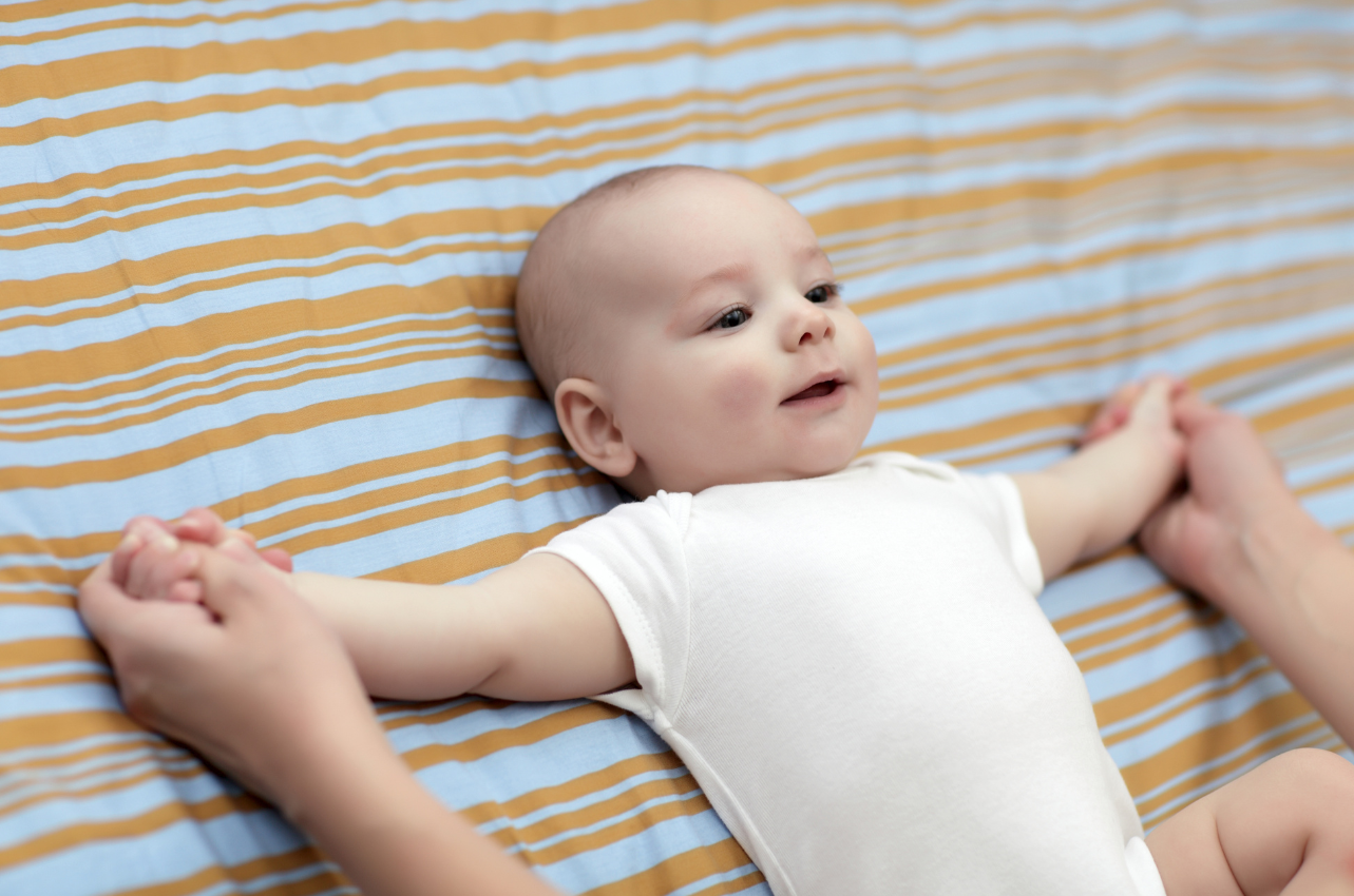 Baby laying on mattress // Healthier Baby Today