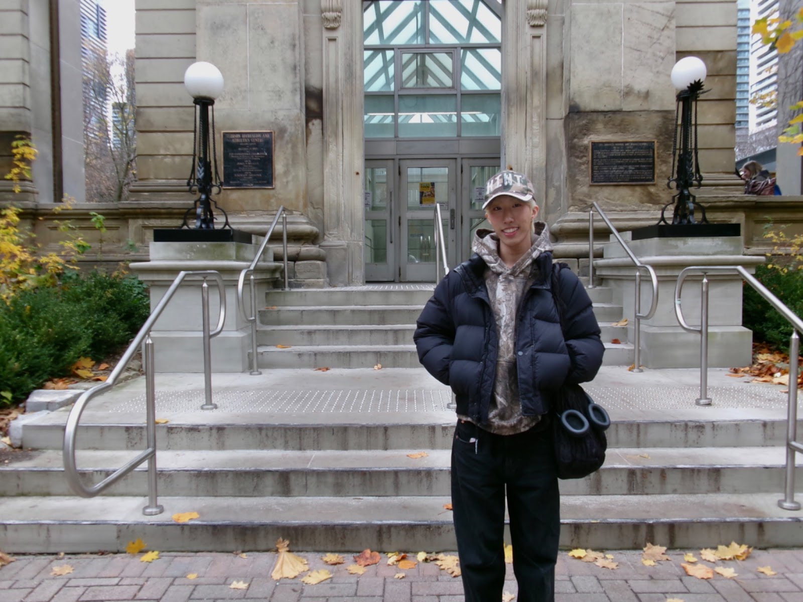 A man posed in front of a building