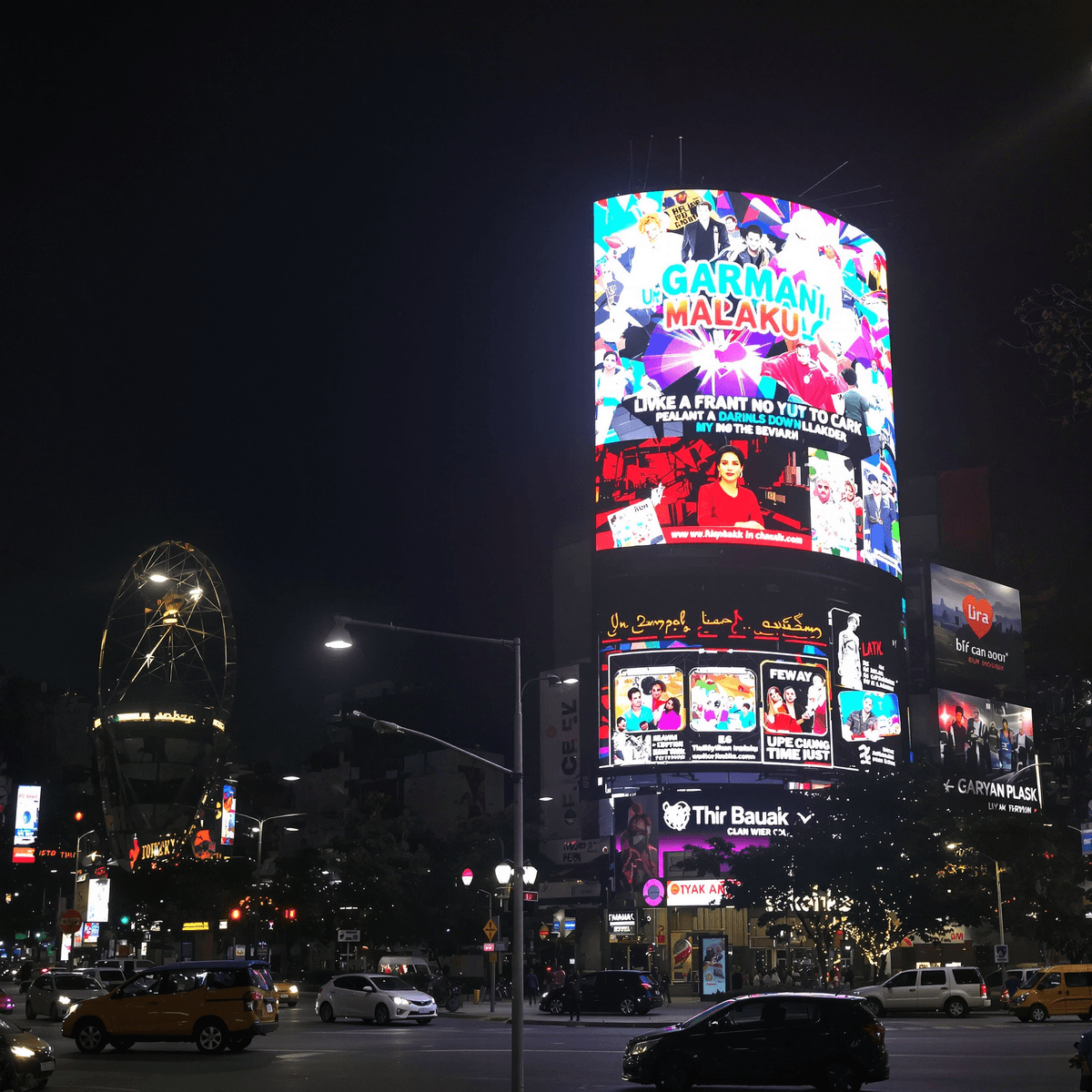 Bright LED billboard glowing at night with colorful digital ads in a busy urban street scene.