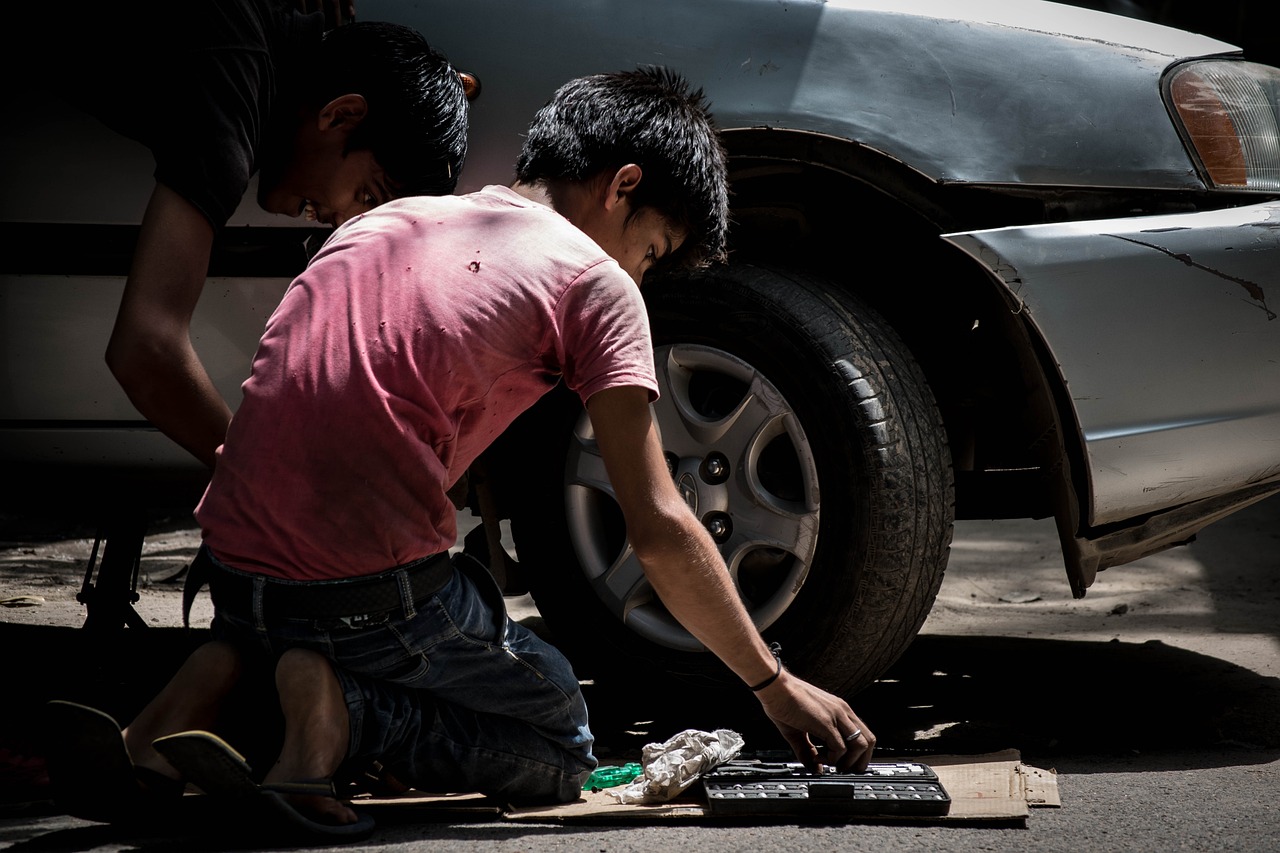 Asian car mechanic working outdoor under the sun