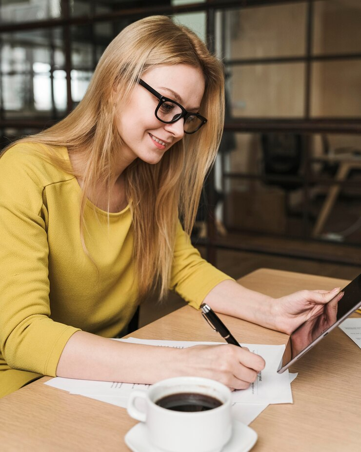 Side view of smiling businesswoman working at a desk