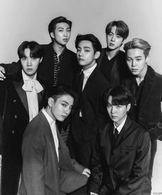 This contain BTS black and white photograph of young men in suits