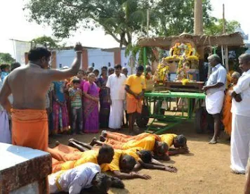 A group of people praying outside

Description automatically generated