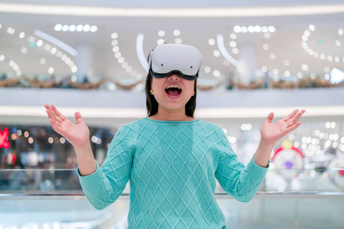  A woman wearing a VR headset in a mall, showcasing immersive retail technology.