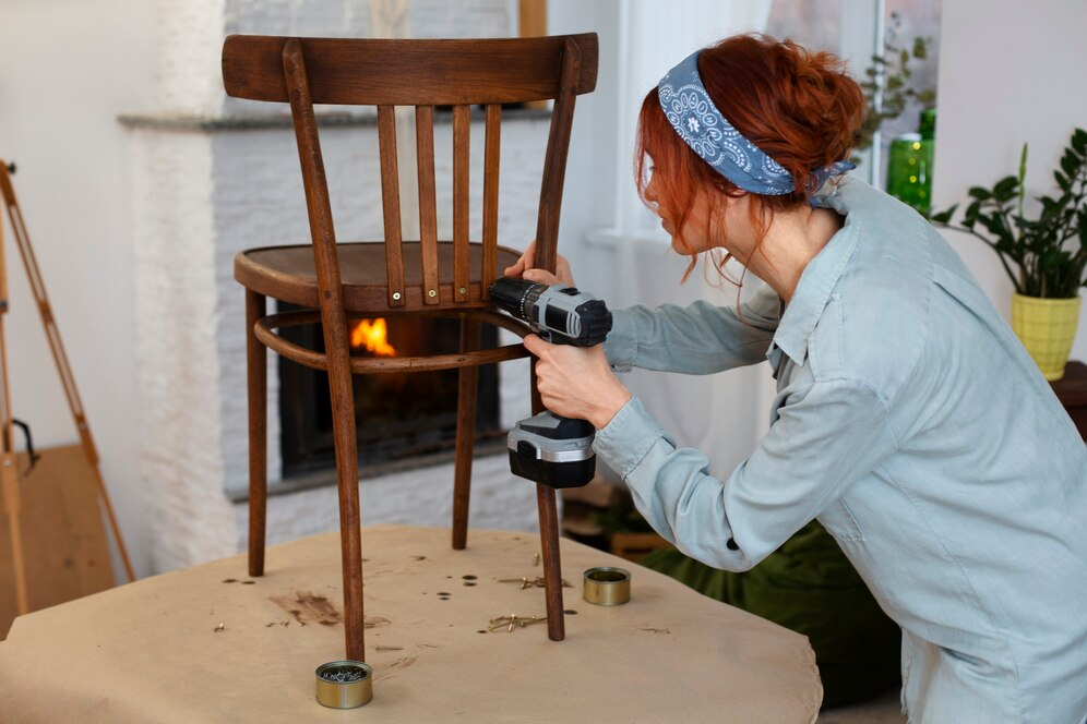 person screwing a nail into a chair