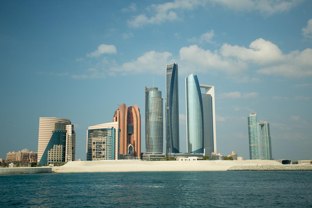 A city skyline with tall buildings on the water

