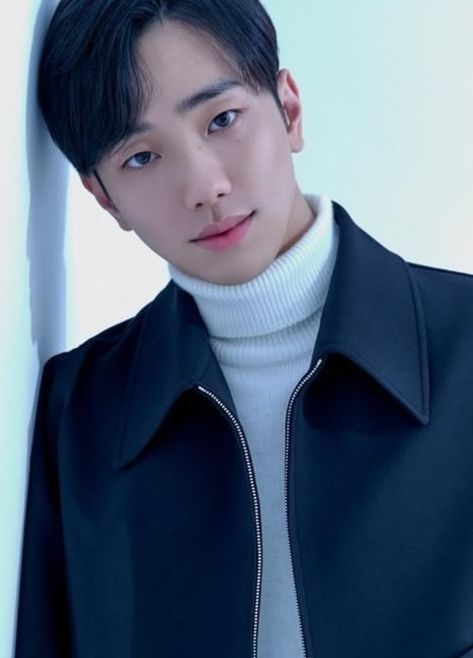 This contains an image of Nam Yoon Su on a black jacket and a turtle neck shirt on it looking handsome