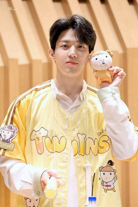 A picture of  DAY6's Dowoon wearing a yellow shirt