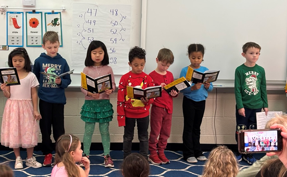 Students from Bonnie Brae Elementary School reading a book during Readers Theatre.