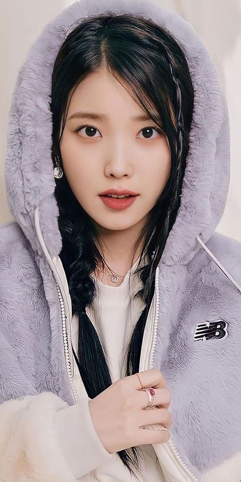 This contains an image of IU wearing a purple hoddie