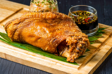 A fried chicken on a cutting board

AI-generated content may be incorrect.