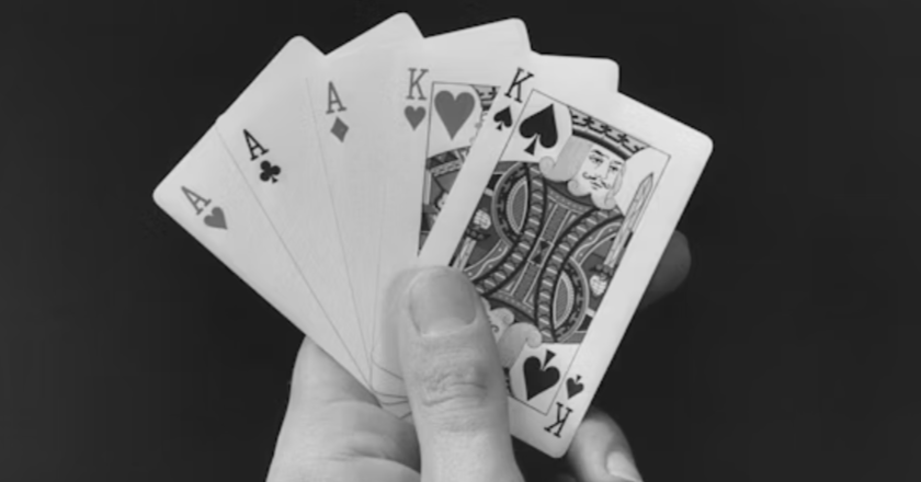 A hand holding playing cards

AI-generated content may be incorrect.