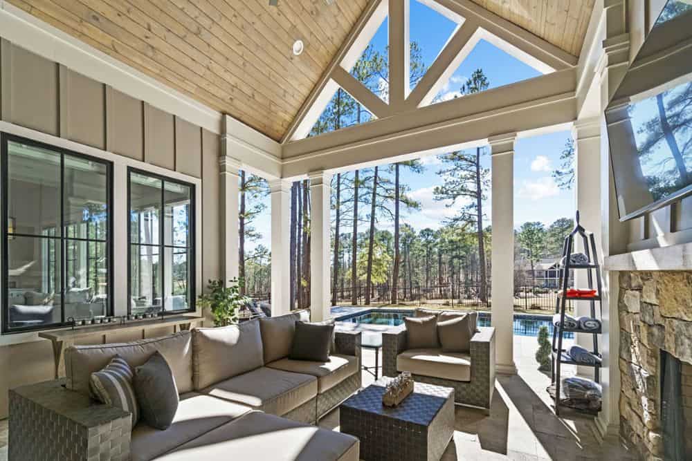 White trusses and columns frame the rear covered porch.