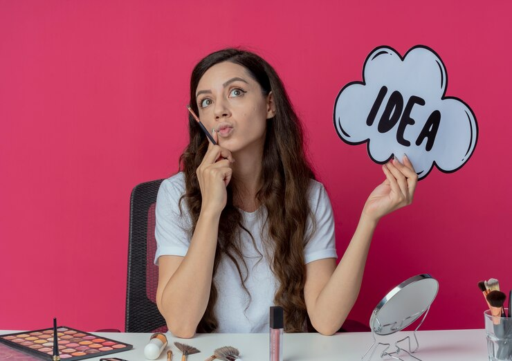 Girl thinking about an idea with the word idea written on a cloud shaped cutout in her hand.