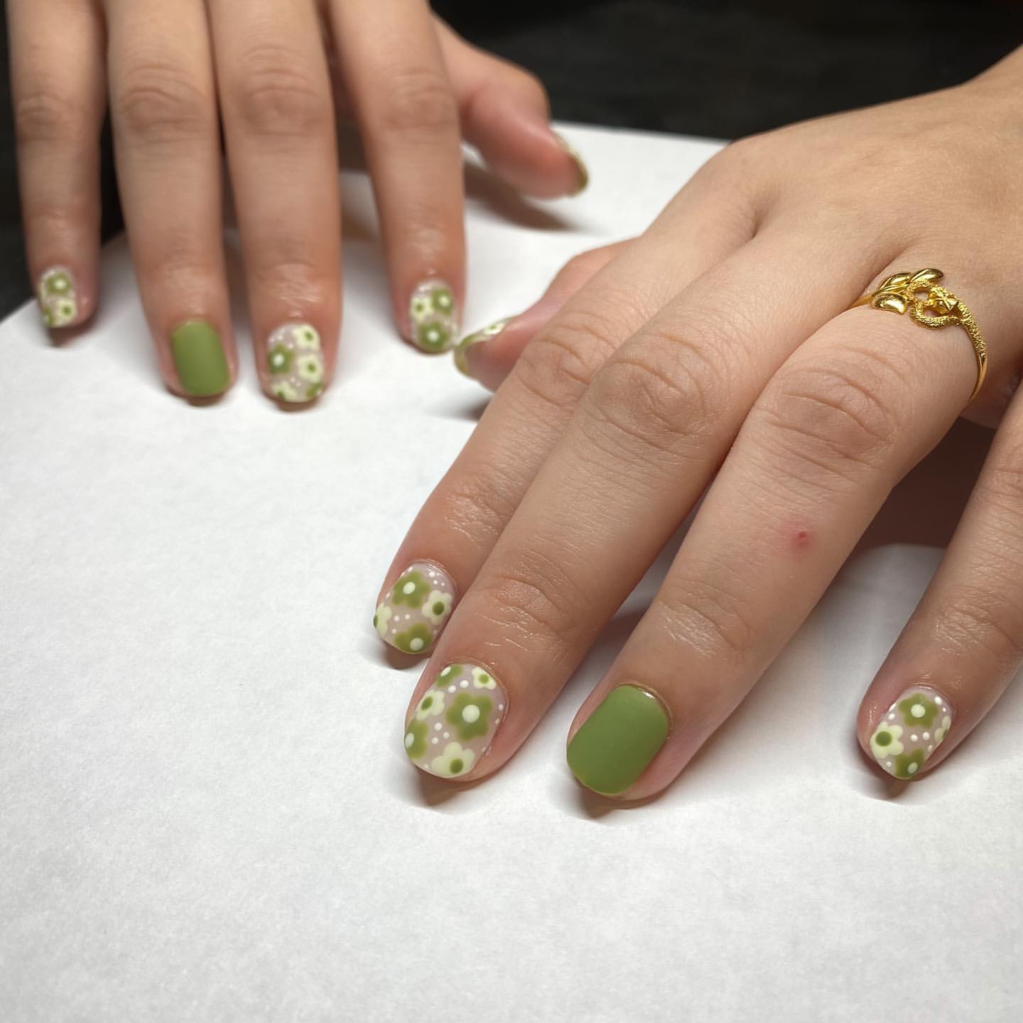 Close-up of hands with fall nail design having Earthy Greens