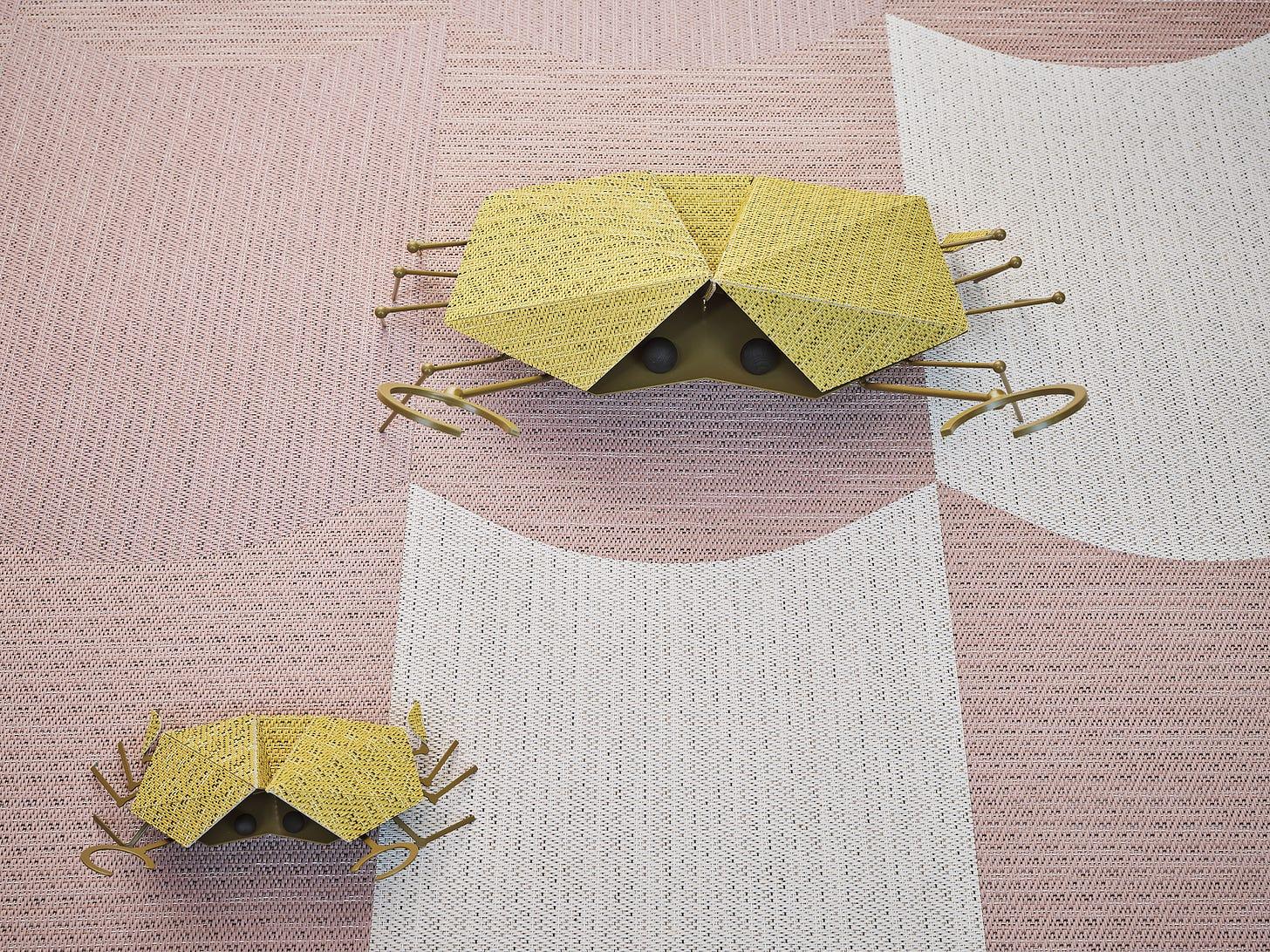 A pair of paper bugs on a pink and white surface

AI-generated content may be incorrect.