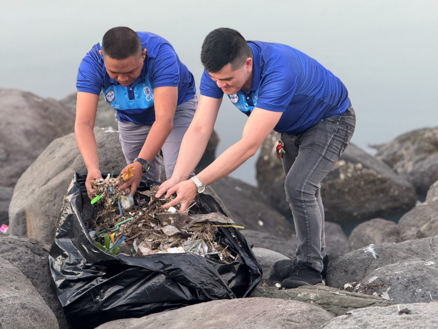 Two men in blue shirts picking up trash

AI-generated content may be incorrect.