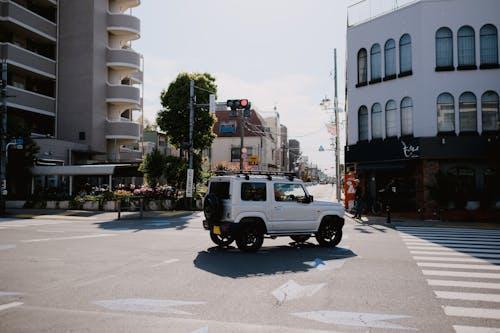 Free A White Suzuki Jimny on an Intersection in City  Stock Photo