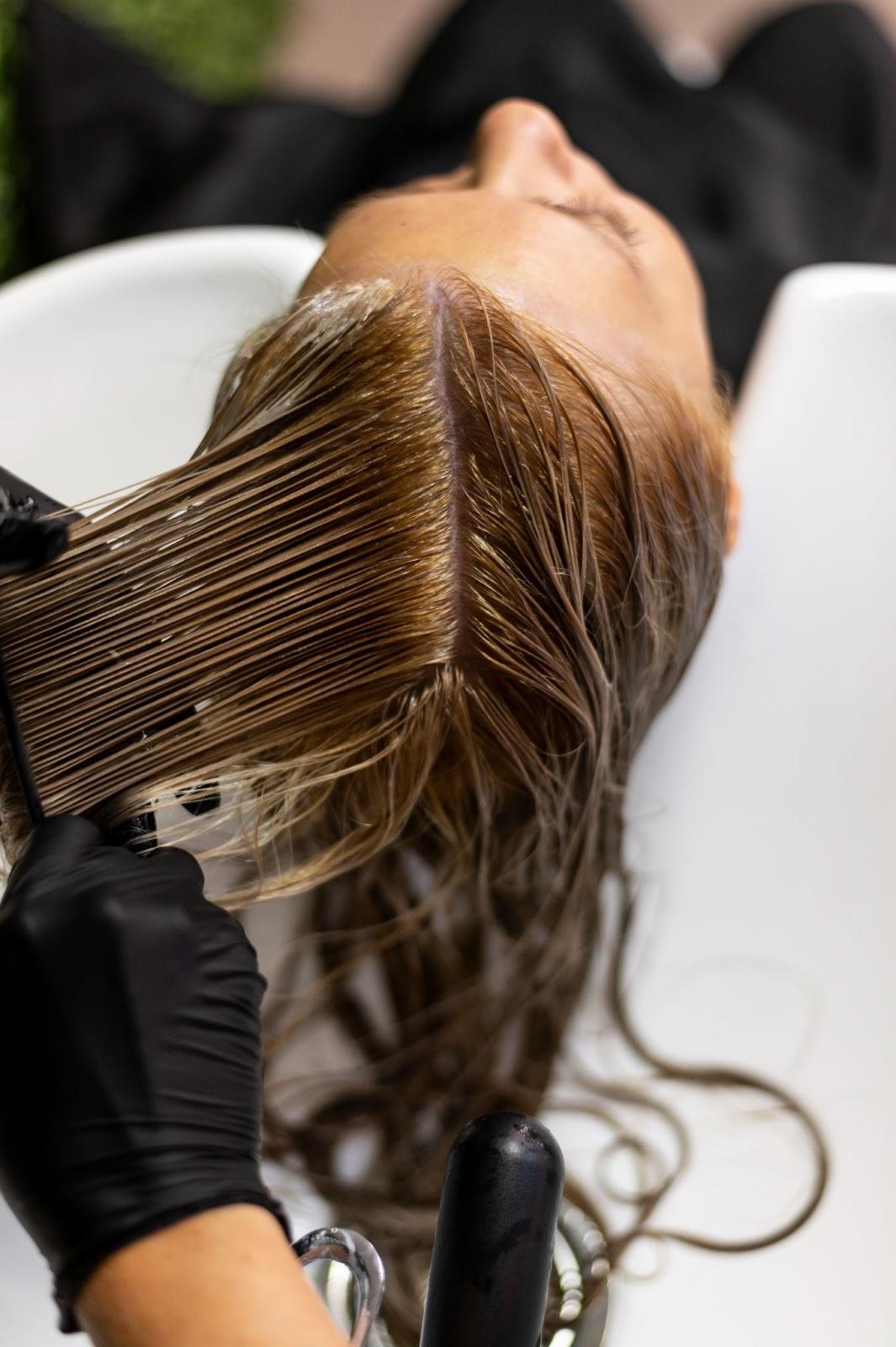 Woman getting her hair washed at a salon