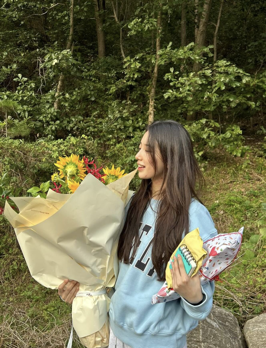 A picture of Suzy holding a bouquet of flowers. 
