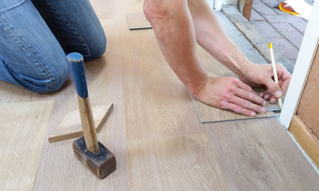 Person laying flooring