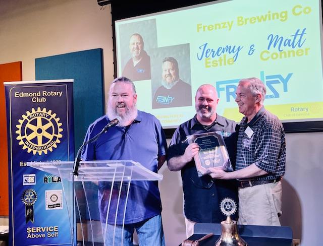 A group of men standing at a podiumDescription automatically generated