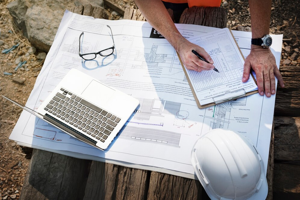 Engineer on a construction site planning a project to avoid challenges in commercial construction