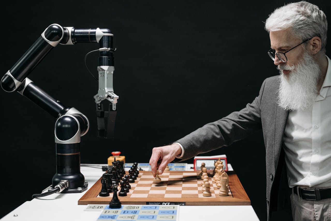 A man playing chess with a robot