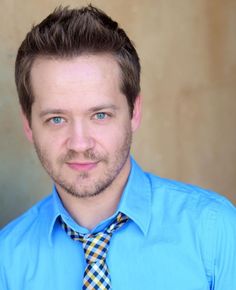 This contain Jason Earles wearing a blue shirt and tie