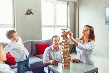 how a home remodeling project can positively impact your family parents and son playing games in living room custom built michigan