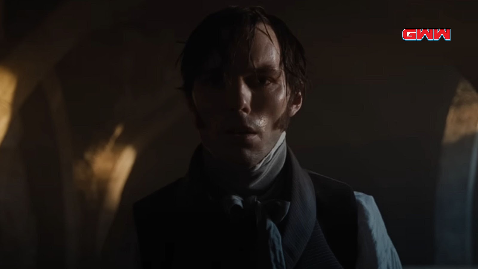 Nicholas Hoult in shadowy scene, looking intense in Nosferatu 2024