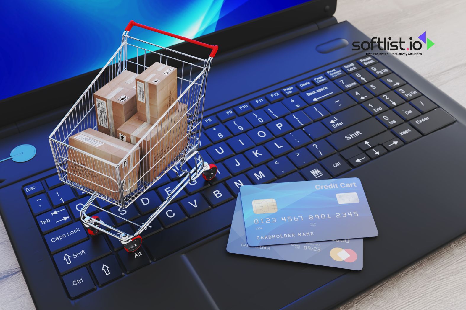 Miniature shopping cart on a laptop keyboard with credit cards displayed.