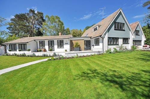 Free White Wooden 2-storey House Near Tree Stock Photo