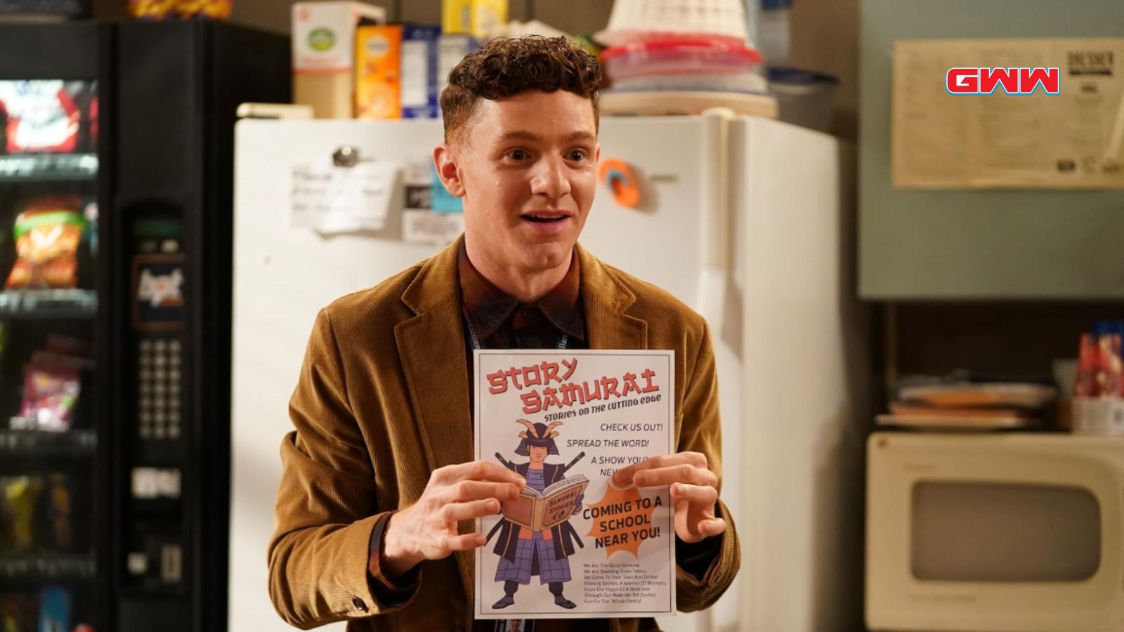 Jacob Hill in a brown blazer holding a flyer for "Story Samurai.