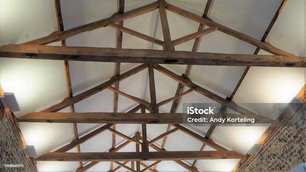 Roof truss or trusses old oak timbers Traditional king post roof truss with open tie beams, rafters, top and bottom chords, king post, struts and purlins. Rooftop Stock Photo