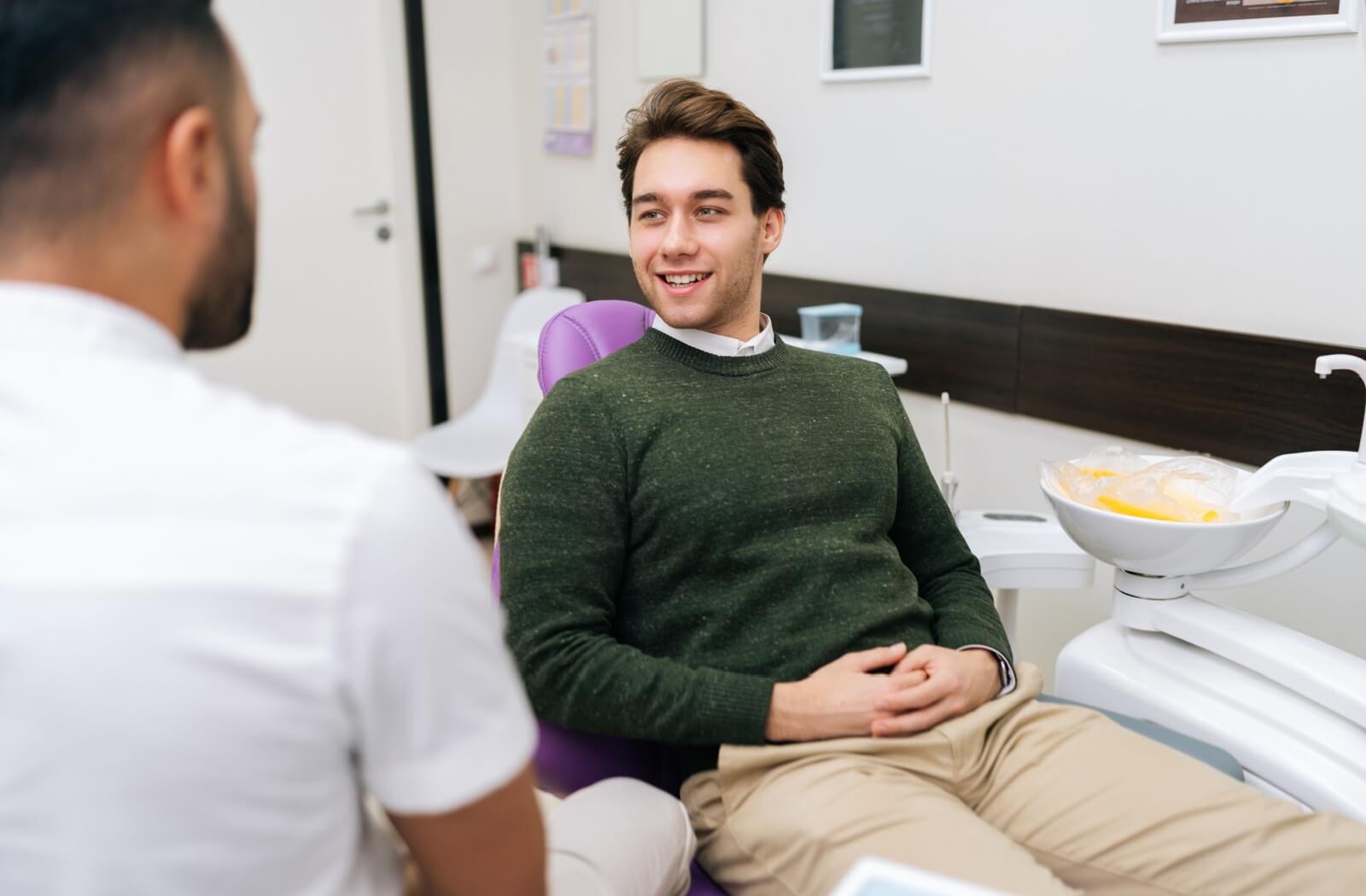 A patient talks to their dentist about sedation dentistry, discussing health history and other information