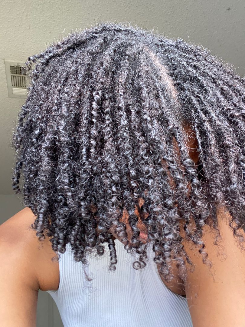 a lady rocking curly microlocs