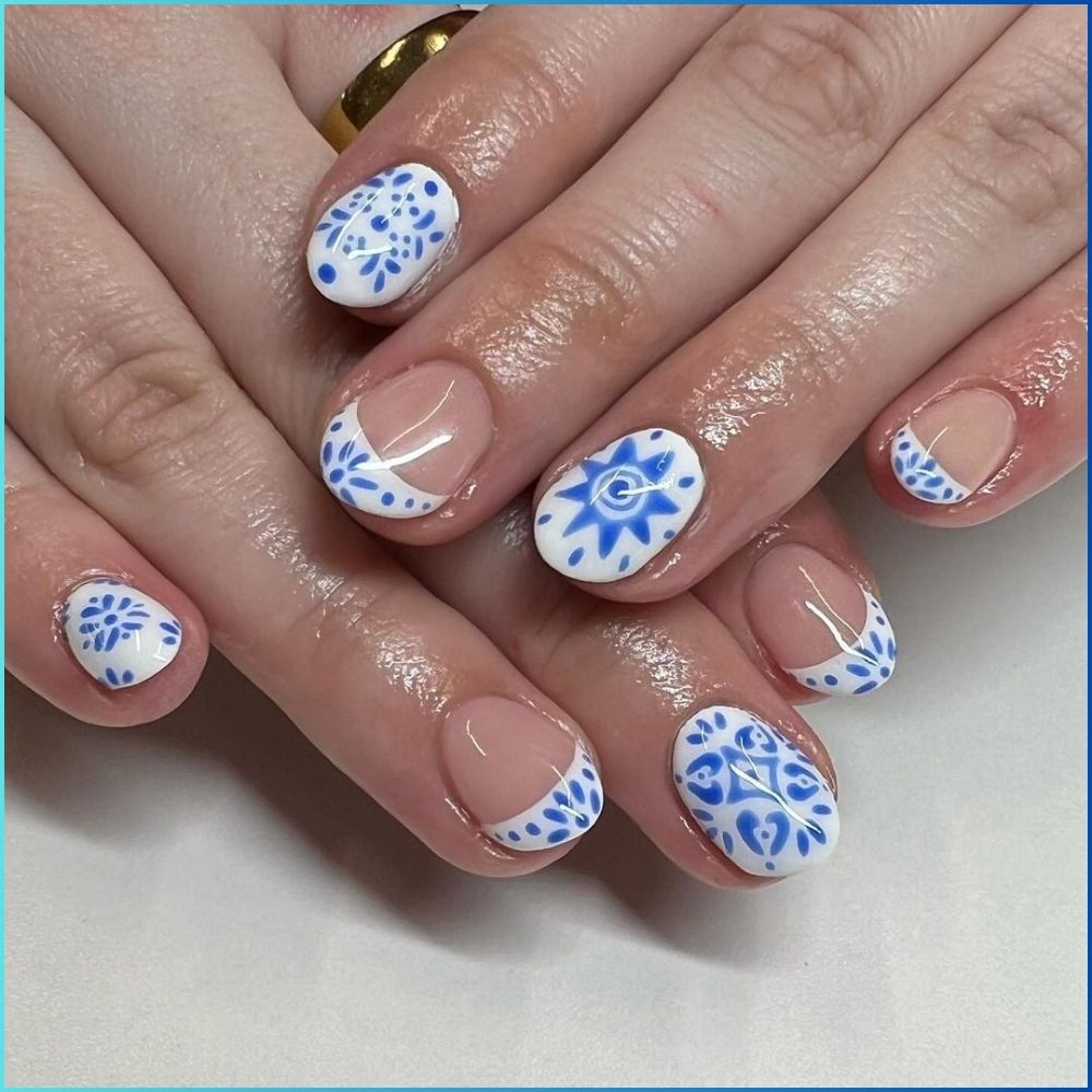 Close up of hands with flowered designed blue nails having Mediterranean Cruise Inspo Nails