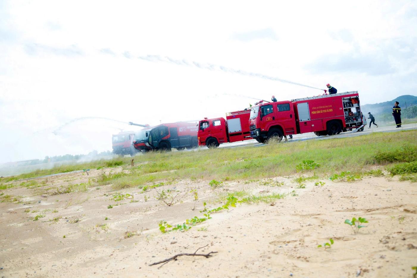 A group of fire trucks spraying waterDescription automatically generated