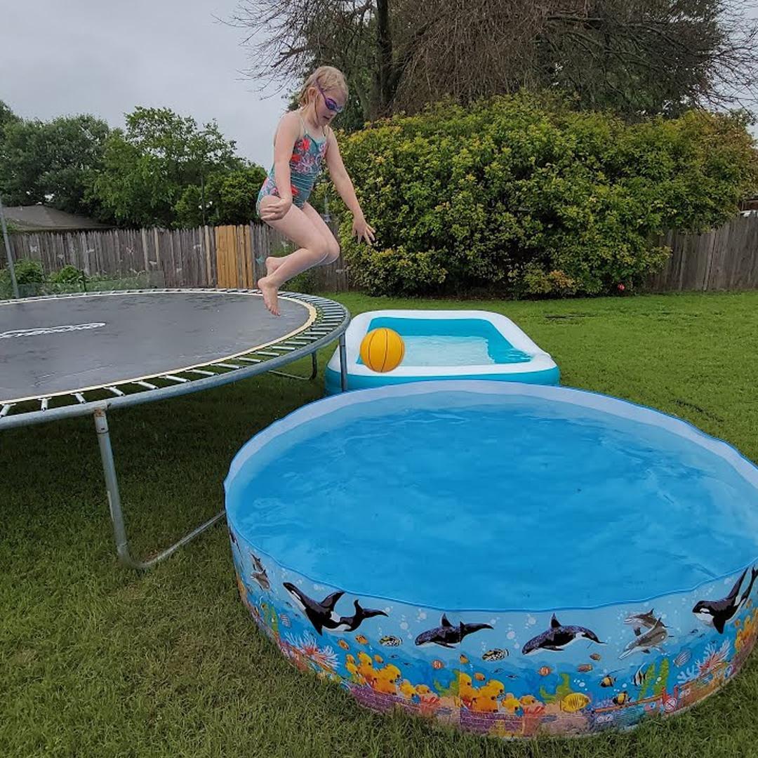 Girl jumping from trampoline to mini pool - supertramp.co.uk