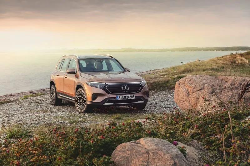 A car parked on a rocky shore

Description automatically generated