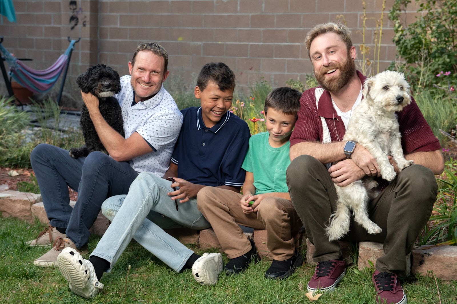 Max and Charlie with their two sons Jaden 12 and Tristen 10 along with their two medium sized dogs.