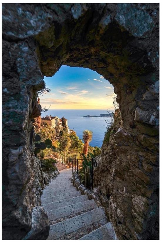 A stone path leading to a body of water

Description automatically generated