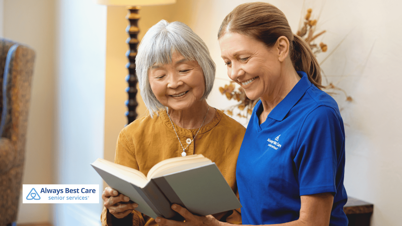 Always Best Care caregiver and senior client reading together 